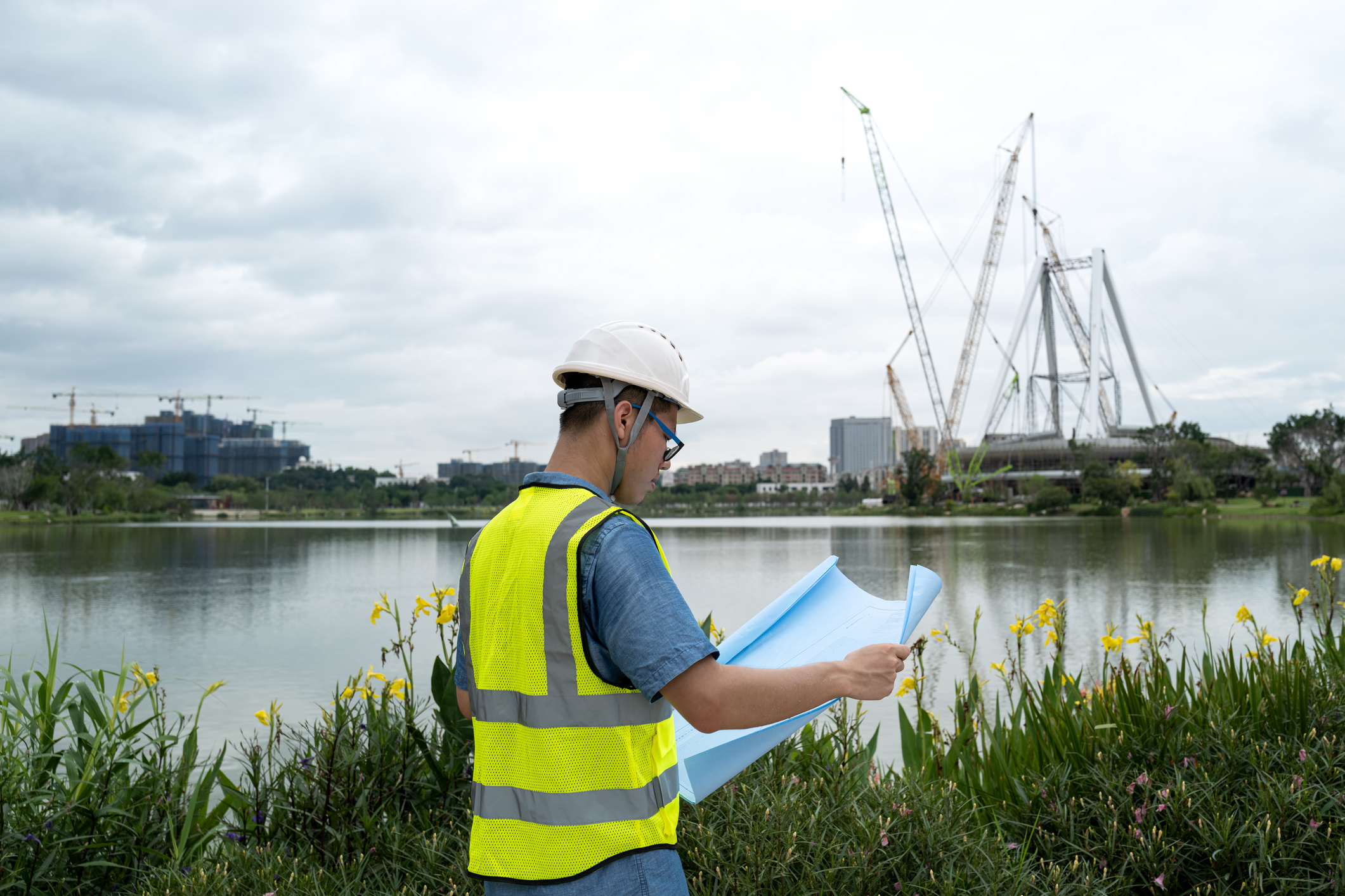 A young Asian male engineer working at a construction site